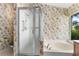 Bathroom featuring a tiled tub, walk in shower, and designer wall paper at 200 Gala Cir, Daytona Beach, FL 32124
