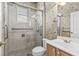 Bathroom featuring a glass door shower with handrails, toilet, and vanity with a sink at 200 Gala Cir, Daytona Beach, FL 32124