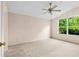 Carpeted bedroom featuring a ceiling fan and window providing natural light at 200 Gala Cir, Daytona Beach, FL 32124