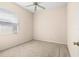 Cozy bedroom features plush carpet, a ceiling fan, and a window for natural light at 200 Gala Cir, Daytona Beach, FL 32124