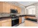 Well-lit kitchen featuring stainless steel appliances, tile backsplash and countertops and eat in bar at 200 Gala Cir, Daytona Beach, FL 32124