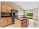 Eat-in kitchen area with stainless steel refrigerator, tile flooring, and sliding glass doors to back yard at 200 Gala Cir, Daytona Beach, FL 32124
