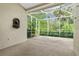 Large screened lanai with outdoor wall decor surrounded by mature landscaping at 200 Gala Cir, Daytona Beach, FL 32124