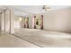 Spacious living room with a chandelier, large windows, and a comfortable carpeted area at 200 Gala Cir, Daytona Beach, FL 32124