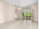 Spacious living room with tiled flooring, ceiling fan, and sliding glass doors to outdoor patio at 200 Gala Cir, Daytona Beach, FL 32124
