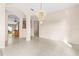 Bright, spacious living room with tile floors, arched doorways, and elegant light fixture at 200 Gala Cir, Daytona Beach, FL 32124
