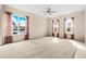 Large living room with natural light, ceiling fan, and plush carpeting at 200 Gala Cir, Daytona Beach, FL 32124