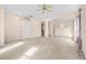 Open floor plan with carpeted living area and tiled walkway with arched entryway to kitchen at 200 Gala Cir, Daytona Beach, FL 32124