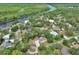 Scenic aerial view of a riverside community with lush greenery and waterfront homes at 2004 Quail Hollow Dr, Deland, FL 32720