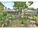 Beautiful backyard view showcasing lush landscaping and a screened patio, creating a serene outdoor space at 2004 Quail Hollow Dr, Deland, FL 32720