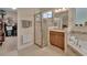 Bright bathroom with a glass-enclosed shower, soaking tub, and a vanity with a granite countertop at 2004 Quail Hollow Dr, Deland, FL 32720