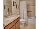 Bathroom featuring granite countertop vanity, with tub and shower combo and tiled walls at 2004 Quail Hollow Dr, Deland, FL 32720