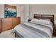 Bedroom with a queen bed, wood furniture, a view of a serene landscape on the TV, and neutral decor at 2004 Quail Hollow Dr, Deland, FL 32720