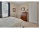 Bedroom featuring a large window, wood furniture, and neutral decor, creating a calming atmosphere at 2004 Quail Hollow Dr, Deland, FL 32720