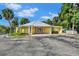 Exterior shot of yellow block community clubhouse on a sunny day at 2004 Quail Hollow Dr, Deland, FL 32720