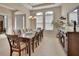 Spacious dining room with natural lighting, neutral decor, and a decorative chandelier at 2004 Quail Hollow Dr, Deland, FL 32720