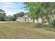 Charming single-story home with well-maintained lawn and mature trees at 2004 Quail Hollow Dr, Deland, FL 32720
