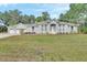 Charming single-story home with a well-maintained lawn and attached two-car garage at 2004 Quail Hollow Dr, Deland, FL 32720