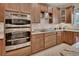 Well-equipped kitchen with stainless steel ovens, a glass cooktop, and granite countertops at 2004 Quail Hollow Dr, Deland, FL 32720