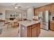 Gourmet kitchen featuring a center island, stainless steel appliances, and wood cabinetry at 2004 Quail Hollow Dr, Deland, FL 32720