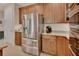 Modern kitchen featuring stainless steel appliances, granite countertops, and wood cabinets at 2004 Quail Hollow Dr, Deland, FL 32720