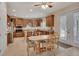 Open kitchen with stainless appliances, wood cabinets, a dining area, and natural light at 2004 Quail Hollow Dr, Deland, FL 32720