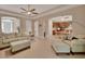 Spacious living room with plush seating, tile floors, and seamless flow to the kitchen at 2004 Quail Hollow Dr, Deland, FL 32720
