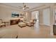 Bright and open living room with tile flooring, a ceiling fan, and easy access to other rooms at 2004 Quail Hollow Dr, Deland, FL 32720