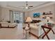 Relaxing living room with tile flooring, a ceiling fan, and sliding glass doors to the lanai at 2004 Quail Hollow Dr, Deland, FL 32720