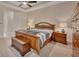 Comfortable bedroom with a ceiling fan, and a chest at the foot of the bed at 2004 Quail Hollow Dr, Deland, FL 32720