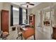 Home office with a wooden desk, built-in shelving, and natural light from the windows at 2004 Quail Hollow Dr, Deland, FL 32720