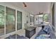 The screened in patio features tiled flooring, ceiling fans, and an outdoor lounge at 2004 Quail Hollow Dr, Deland, FL 32720