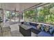 Inviting screened patio with tile floor, ceiling fan, and comfortable seating area, perfect for relaxation at 2004 Quail Hollow Dr, Deland, FL 32720