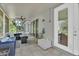 Covered and screened patio area featuring tiled floors and comfortable seating, ideal for enjoying the outdoors at 2004 Quail Hollow Dr, Deland, FL 32720