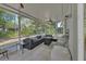 Relaxing screened patio with comfortable seating, ceiling fan, and scenic outdoor views at 2004 Quail Hollow Dr, Deland, FL 32720