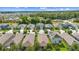 Aerial view of a residential neighborhood showcasing well-maintained homes and mature trees at 211 Duke Dr, Deland, FL 32724