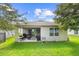 Spacious backyard with a covered patio, perfect for entertaining and enjoying the outdoors at 211 Duke Dr, Deland, FL 32724
