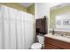 Bathroom featuring granite vanity with a wood cabinet, toilet, and white shower curtain at 211 Duke Dr, Deland, FL 32724