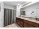 Well-lit bathroom featuring a double vanity with granite countertops and ample storage at 211 Duke Dr, Deland, FL 32724