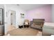 Charming Bedroom with crib, accent chair, decor, and pink accent wall at 211 Duke Dr, Deland, FL 32724