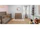 Cozy Bedroom featuring a crib, changing table, and soft neutral tones at 211 Duke Dr, Deland, FL 32724