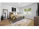 Stylish bedroom featuring a comfortable bed, large window, and modern décor at 211 Duke Dr, Deland, FL 32724