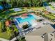 Aerial view of a community pool and recreation area with ample seating and lush landscaping at 211 Duke Dr, Deland, FL 32724