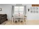 Bright dining area with a table set for four, neutral walls and view to the living room at 211 Duke Dr, Deland, FL 32724