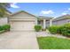 Charming single-story home featuring a two-car garage, well-manicured lawn, and welcoming curb appeal at 211 Duke Dr, Deland, FL 32724