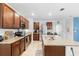Spacious kitchen with an oversized island featuring granite countertops and stainless steel appliances at 211 Duke Dr, Deland, FL 32724