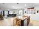 Bright open concept kitchen features a center island with barstool seating and view of the living room at 211 Duke Dr, Deland, FL 32724