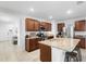 Bright kitchen with granite countertops, a center island with barstool seating, and stainless steel appliances at 211 Duke Dr, Deland, FL 32724