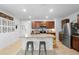 Open concept kitchen features a center island with barstool seating, granite countertops, and stainless appliances at 211 Duke Dr, Deland, FL 32724