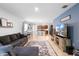An open concept living room with view to the kitchen, dining area, gray sectional couch and decor at 211 Duke Dr, Deland, FL 32724